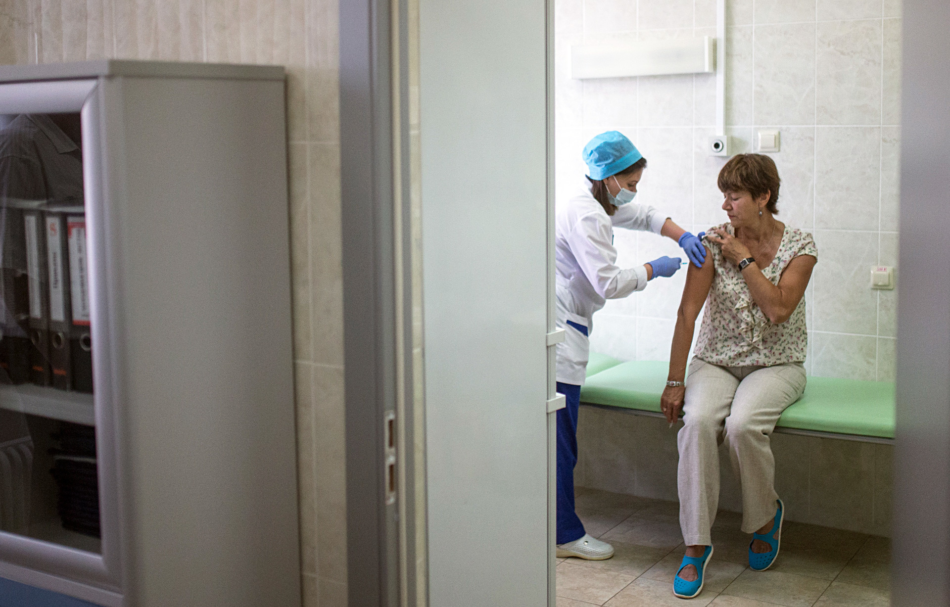 A patient gets a vaccination at Moscow public outpatient clinic. The medical care in Russia is far from ideal but it remains free by now.