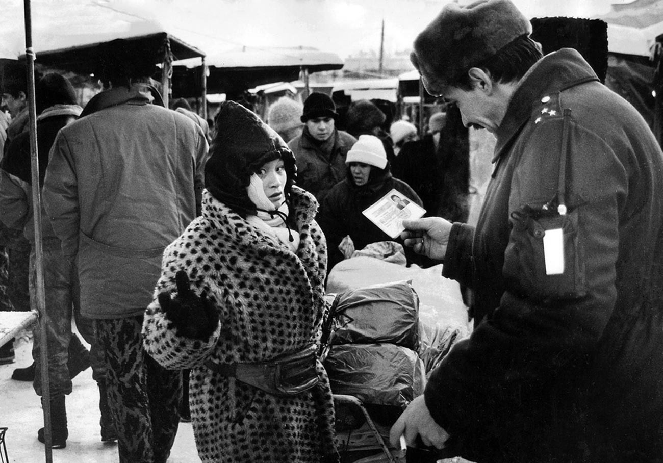 Checking passports at a market