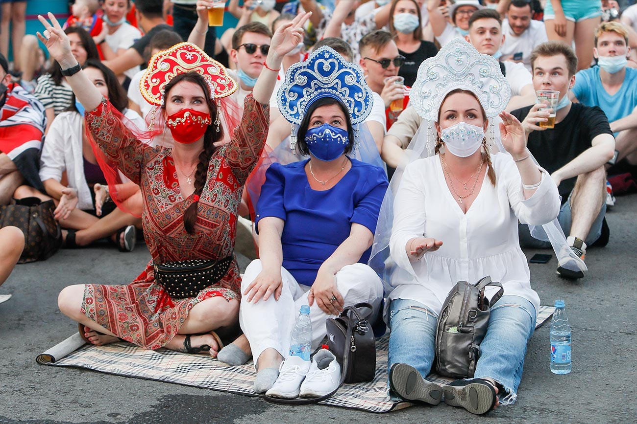 Russian supporters watch a live stream during the UEFA Euro 2020 Championship match between Denmark and Russia on June 21, 2021 at Fan Zone at Konyushennaya square in Saint Petersburg, Russia. 