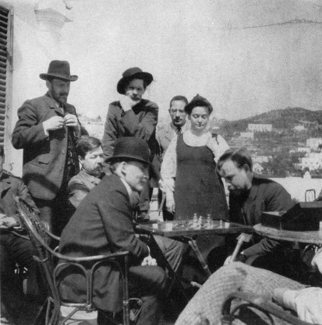 Vladimir Lenin plays chess with Alexander Bogdanov, 1908, Capri. Zinovy Peshkov is the second from the right in the top row, next to him is Maxim Gorky.