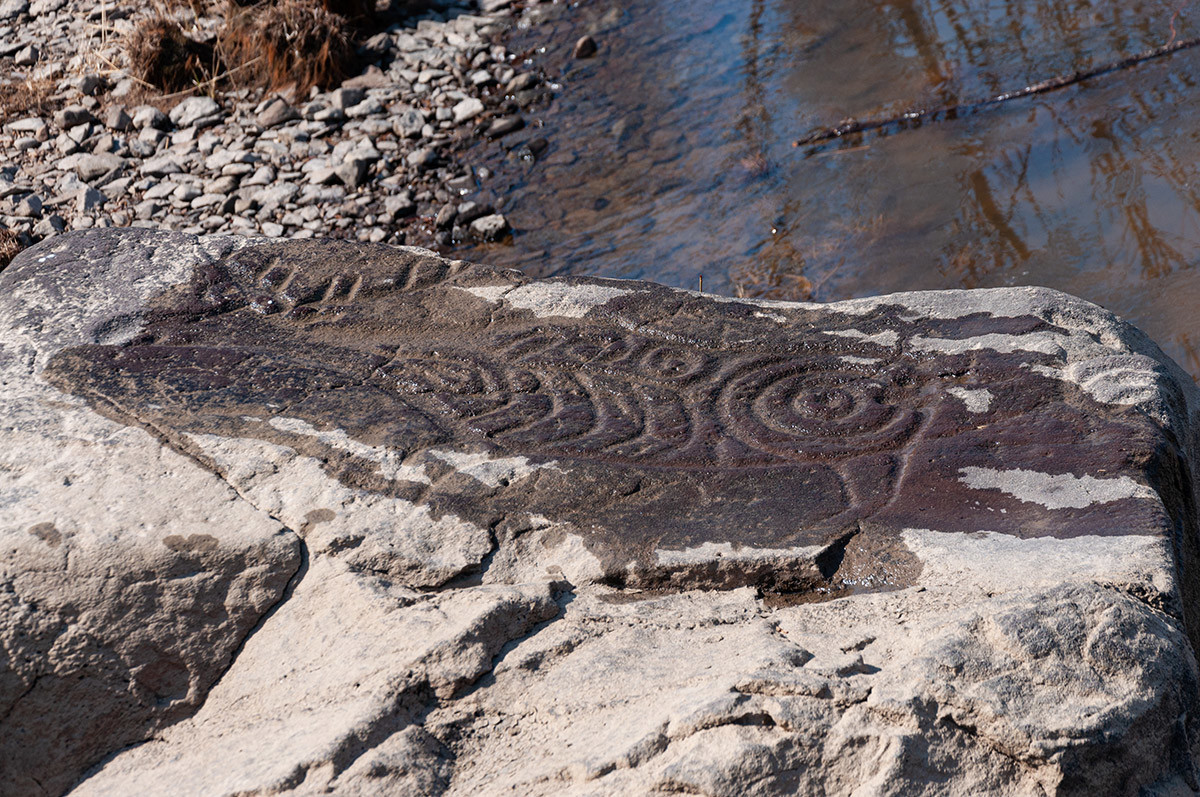 Petrogliphs on the stones on the bank of Amur river