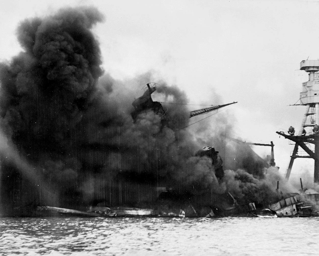 The USS Arizona sinking in a cloud of smoke after the Japanese attack on Pearl Harbor during World War II.