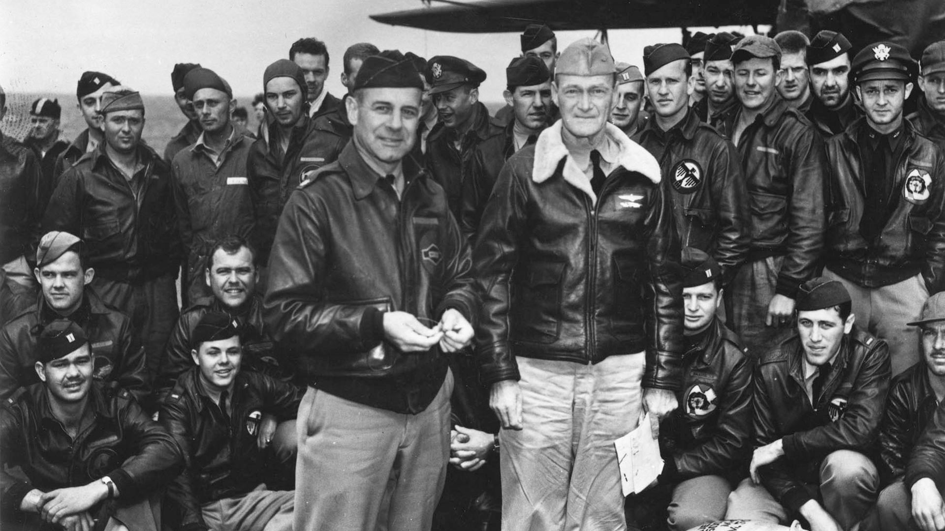 Lieutenant Colonel James H. Doolittle (left front) poses with USAAF aircrew members on Hornet's flight deck.