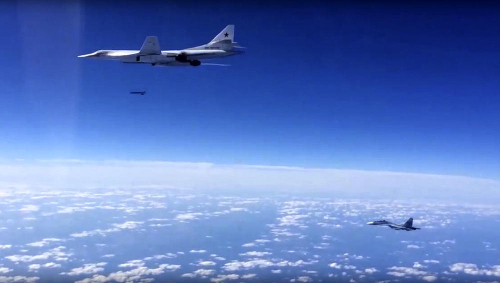 Russian air force Tu-160 bomber launches a cruise missile while being escorted by an Su-30SM on a combat mission against a target in Syria. / Source: AP 