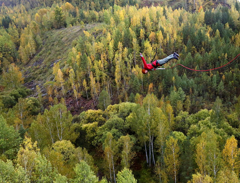 A member of the "Exit Point"  team jumps from a 44-meter high (144-ft) waterpipe bridge in the Siberian Taiga area outside Krasnoyarsk.  / Reuters