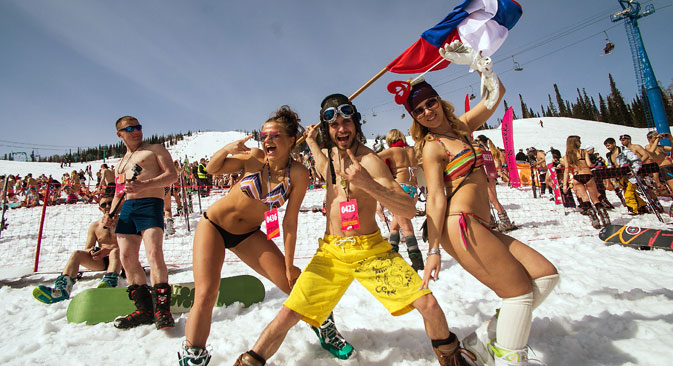 People wearing bathing suits during an annual event at Sheregesh ski resort. More than 100 half naked skiers and snowboarders wearing bermuda shorts and bikinis took part in a mass downhill run in a bid to break the Guiness World Record. 
