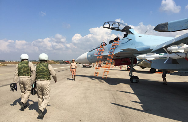 The crew of a Russian Su-30 fighter prepare to take off at Hmeimim aerodrome in Syria.