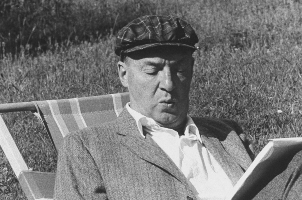 Vladimir Nabokov writing on paper in the garden. Source: Getty Images
