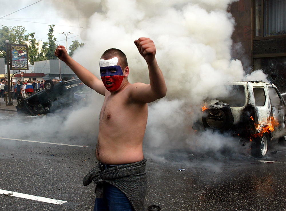 A football fan shouts in front of a burning car in central Moscow June 9, 2002. Source: Reuters