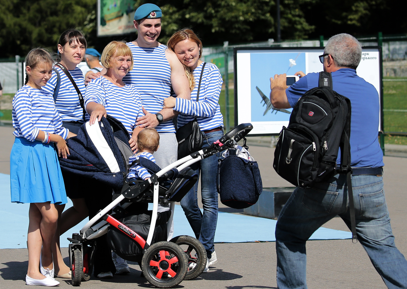  Former Russian paratrooper with his family poses for the picture at the Gorky Park, during the Russian 'Paratroopers Day' celebrations in Moscow. Source: EPA
