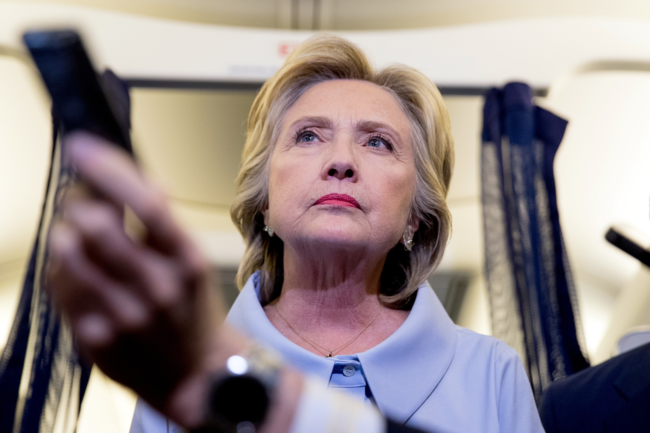 Democratic presidential candidate Hillary Clinton takes a question from a member of the media on her campaign plane while traveling to Quad Cities International Airport in Moline, Sept. 5, 2016.