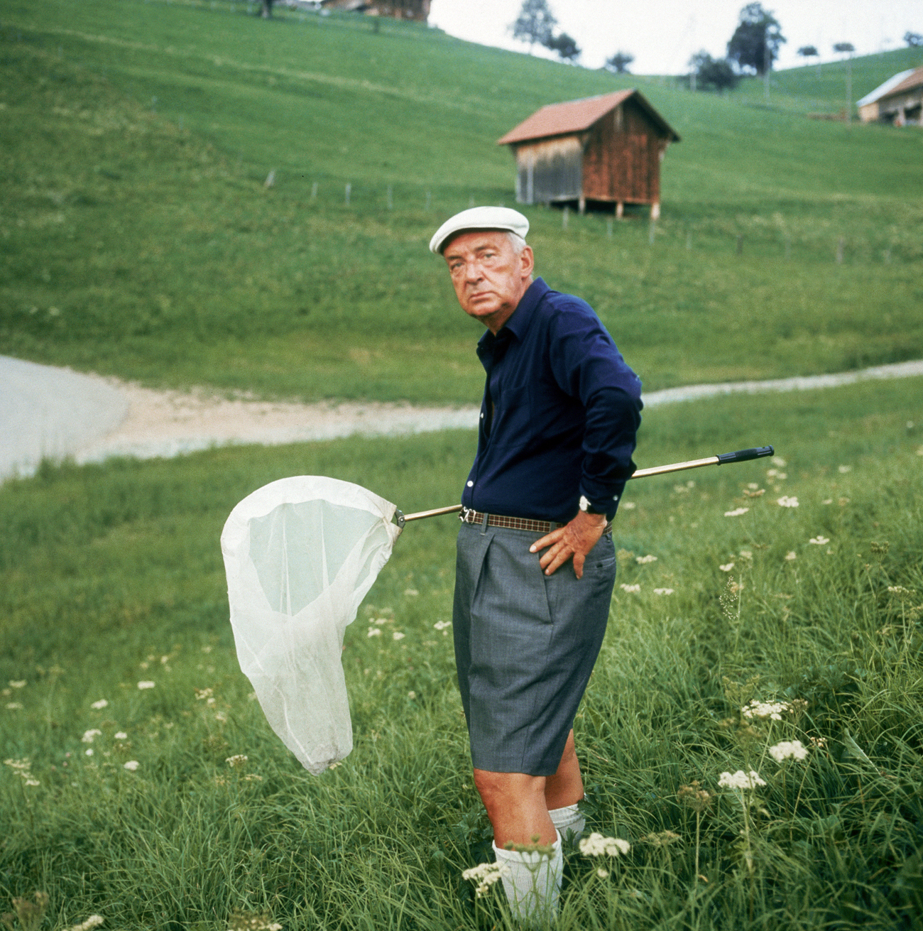 Circa 1975: Portrait of Russian-born American writer Vladimir Nabokov (1899 - 1977) standing with a butterfly net outdoors in the hills of Switzerland. Source: Getty Images