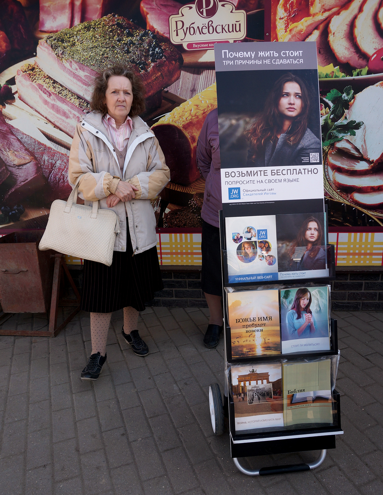 A Russian woman at a street stand offering Jehovah’s Witnesses' literature. Source: Alexander Artemenkov / TASS