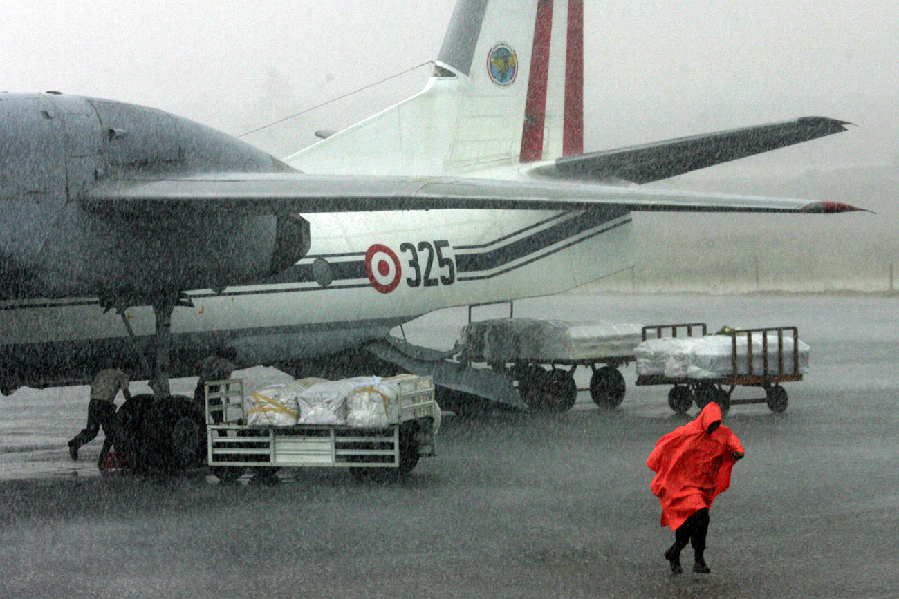 Coffins of Tans Peru airline Boeing 737-200 victims weating to be send to Lima under heavy rain at the tarmac of the Pucallpa's airport before, August 2005. AFP