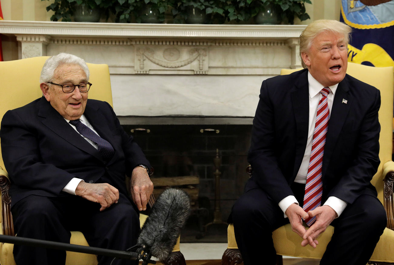 Der ehemalige US-Außenminister Henry Kissinger (l.) sitzt neben Donald Trump, der im Anschluss seines Gesprächs mit dem russischen Außenminister Sergej Lawrow Fragen der Presse beantwortet.  / Reuters