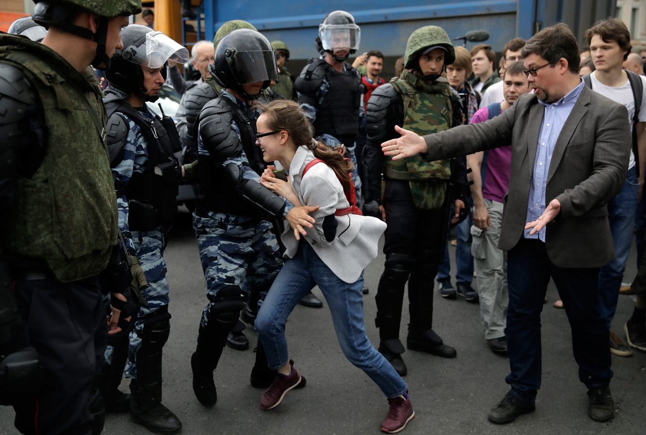 A young girl reacts after her friend was detained by police during a demonstration in downtown Moscow, June 12, 2017.  / AP