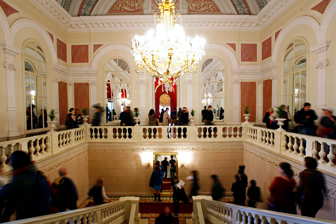 Visitors walk in the newly refurbished foyer of the Bolshoi Theater. / Reuters