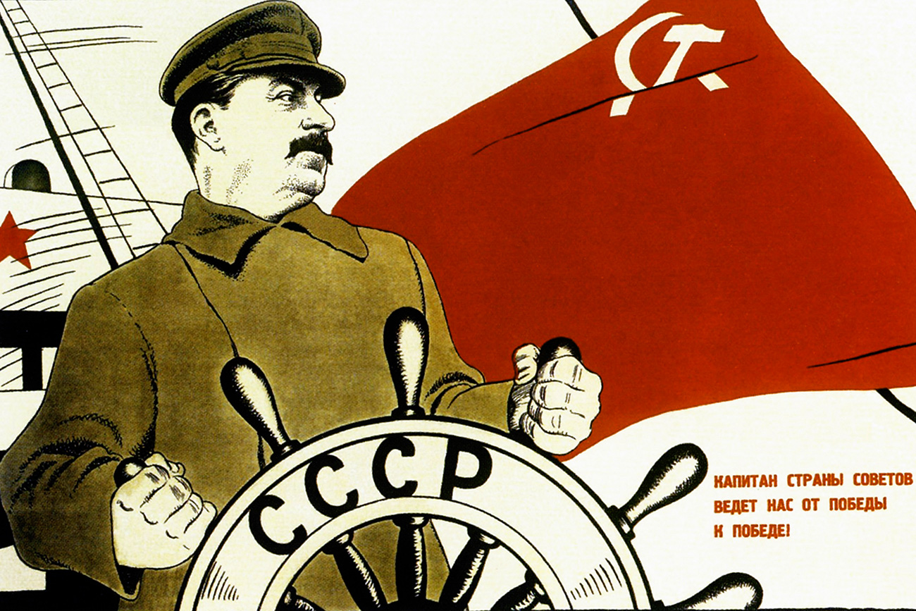Soviet propaganda poster showing a much loved Stalin with a montage of adoring supporters. "The captain of the USSR leads us from one victory to another". 