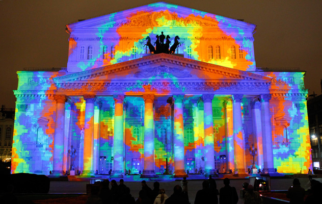 People look at the illuminated Bolshoi Theatre on the eve of its reopening in central Moscow October 27, 2011. Russia's Bolshoi Theater reopens on Friday with a star-studded gala performance after a more than six-year, $700-million restoration dogged by delays and financial scandal to reclaim its place as one of the world's cultural jewels. Picture taken October 27. REUTERS/Sergei Karpukhin