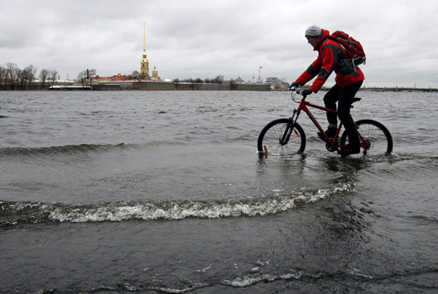 Flood in St Petersburg.   A cyclist riding along the flooded Spit of Vasilyevsky Island.  Credit: RIA Novosti