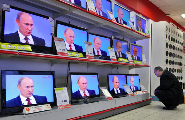 A puzzled customer shopping for a TV set, while the screens broadcast Prime Minister Vladimir Putin's annual Q&A session on December 15, 2011. Putin commented on the results of Russia's 2011 parliamentary elections and protests. He declared that he was pleased with the electoral results and defended the elections as fair. Source: AFP Photo / Alexey Sazonov
