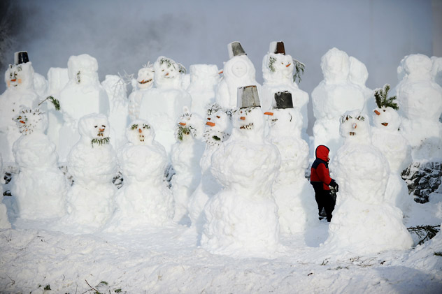 A child walking amidst the numerous snowmen built in a park in central Moscow, on Dec. 29, 2011. New Year's is the biggest holiday of the year in Russia, and is followed by the Orthodox Christmas on Jan. 7.  Source:  AFP/East News