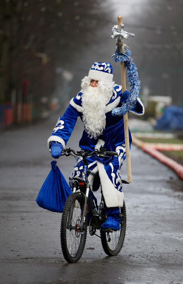 A man, dressed as Grandfather Frost, Russia's counterpart of Santa Claus, riding a bicycle at a city park in Stavropol in southern Russia on Dec. 29, 2011. Source: Reuters/Vostock-Photo