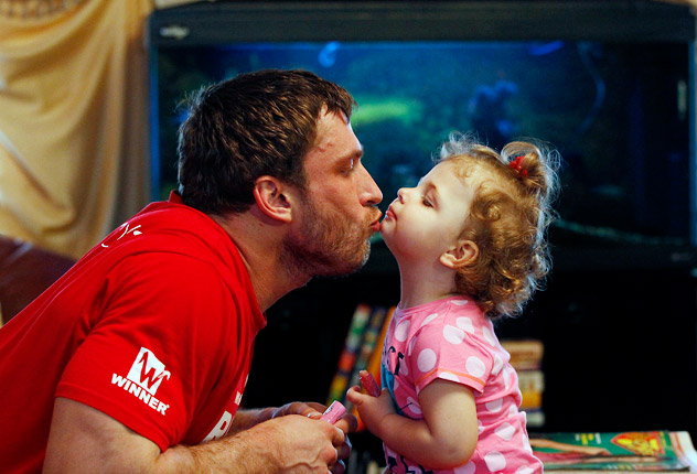Olympic silver medallist in weightlifting Dmitry Klokov plays with his daughter Nastya at his father's house in the village of Sinkovo outside Moscow, April 3, 2012. Klokov will be taking part in the men's 105kg weightlifting competition at the 2012 London Summer Olympics. Source: Reuters / Vostock-Photo