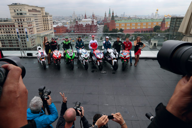 Superbike World Championship riders, from left, Max Biaggi, of Aprilia Racing Team, Tom Sykes, of Kawasaki Racing Team, John Hopkins, of FIXI Crescent Suzuki, Carlos Checa, of Althea Racing Ducati, Leon Halsam, of BMW Motorrad Motorsport and Jonathan Rea, of Honda World Superbike Team, pose during a photo call atop a hotel roof in downtown Moscow, Russia, on Thursday, Aug. 23, 2012. Russia's first ever Superbike Championship event will take place this coming weekend.