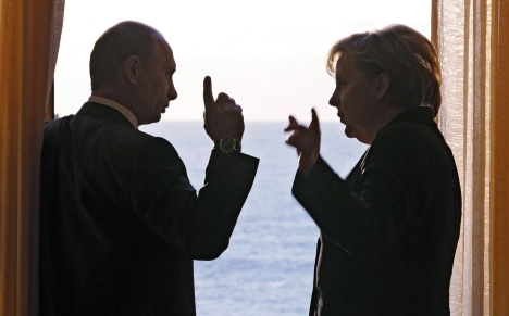 Russian President Vladimir Putin and German Chancellor Angela Merkel discussing the Russian-German relations. Source: AP