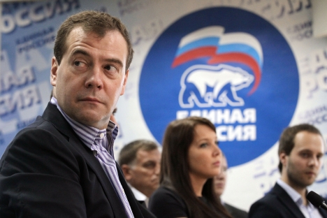  Russian Prime Minister Dmitry Medvedev, left, speaks at the United Russia party conference in St. Petersburg, Russia, Saturday, June 16, 2012. In the background is the emblem of the United Russia party. Source: AP