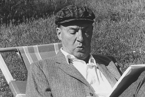 Vladimir Nabokov writing on paper in the garden. Source: Getty Images